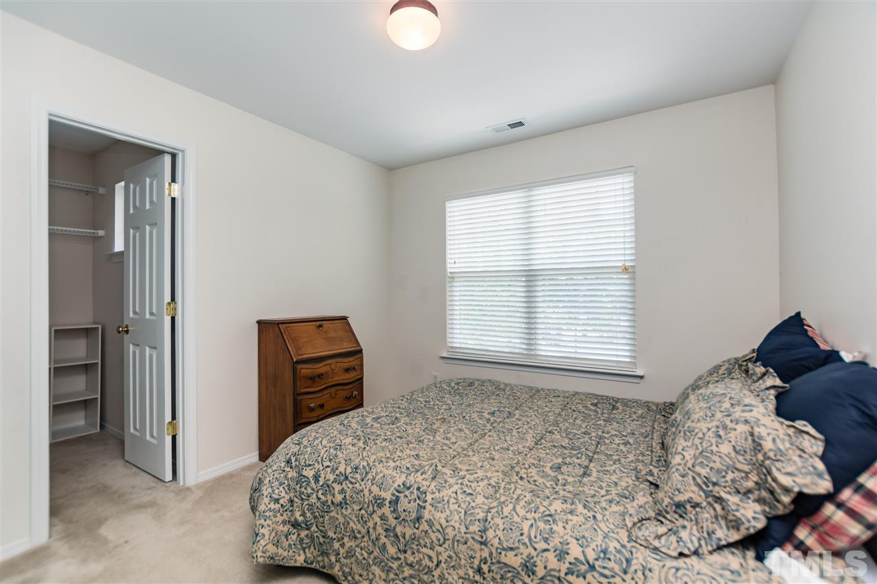 8313 Rubblestone Path Raleigh, NC 27613 - Photo 19 of 25 a bedroom with a bed and a window