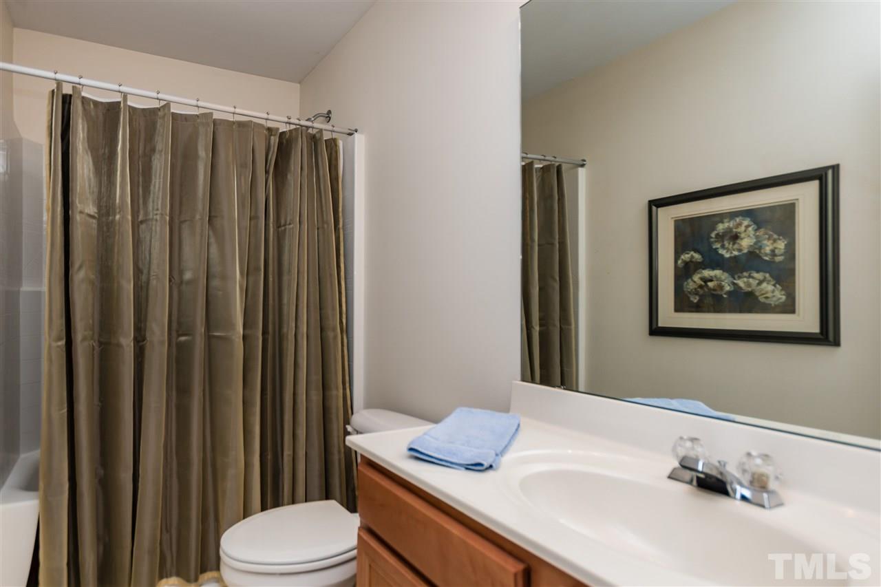 8313 Rubblestone Path Raleigh, NC 27613 - Photo 21 of 25 a bathroom with a sink vanity mirror and toilet