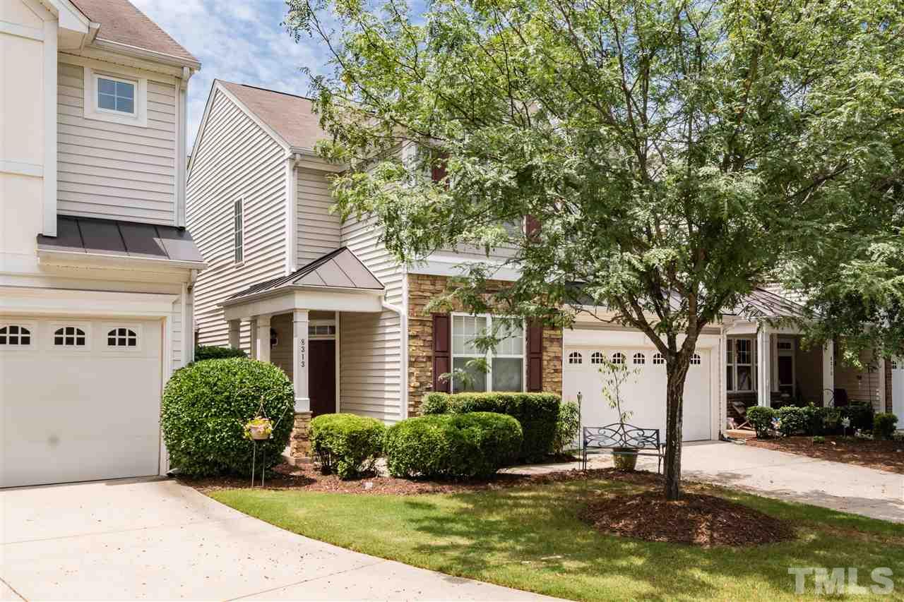 8313 Rubblestone Path Raleigh, NC 27613 - Photo 25 of 25 a view of a white house next to a yard and a tree