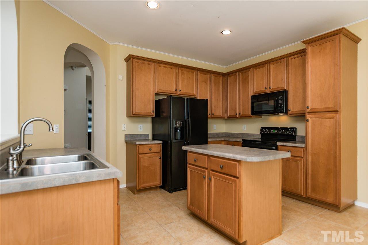 8313 Rubblestone Path Raleigh, NC 27613 - Photo 8 of 25 a kitchen with a refrigerator stove and sink