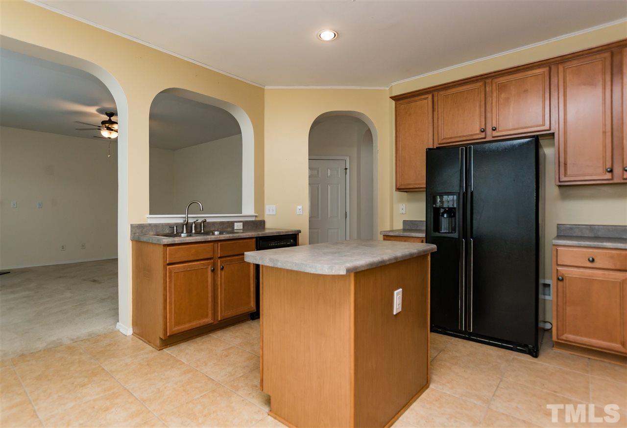 8313 Rubblestone Path Raleigh, NC 27613 - Photo 9 of 25 a kitchen with stainless steel appliances granite countertop a refrigerator and a stove
