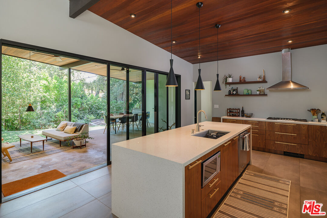 1540 Lancashire Place Pasadena, CA 91103 - Photo 14 of 31 a kitchen with stainless steel appliances granite countertop a sink a stove and a wooden floors