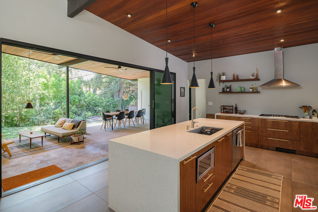 1540 Lancashire Place Pasadena, CA 91103 - Photo 15 of 31 a kitchen with stainless steel appliances granite countertop a sink a stove and a wooden floors