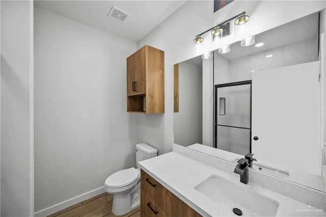 a bathroom with a sink toilet and mirror