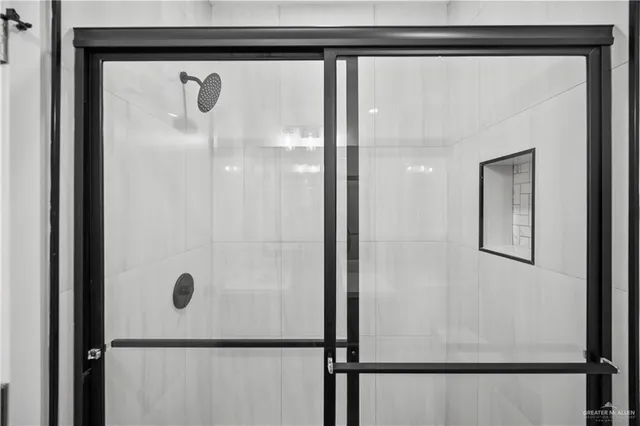 a bathroom with a glass shower door