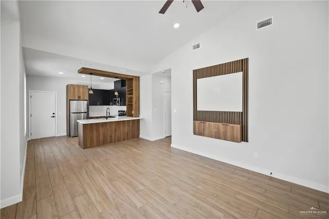 a view of kitchen with sink and wooden floor