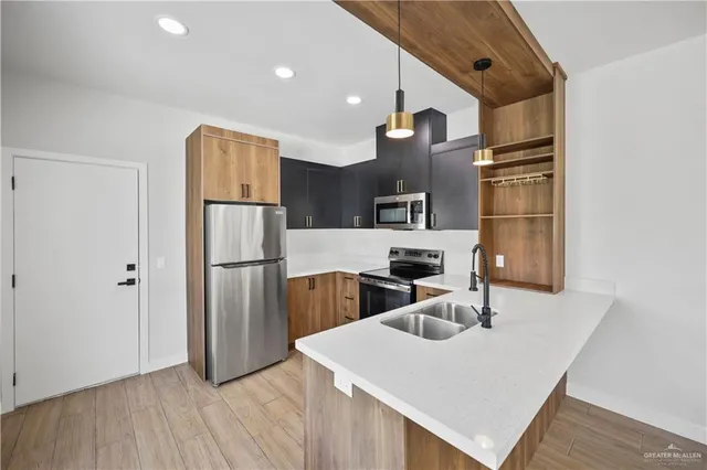a kitchen with a refrigerator a sink and a stove