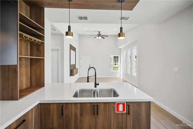 a kitchen with stainless steel appliances granite countertop a sink and refrigerator