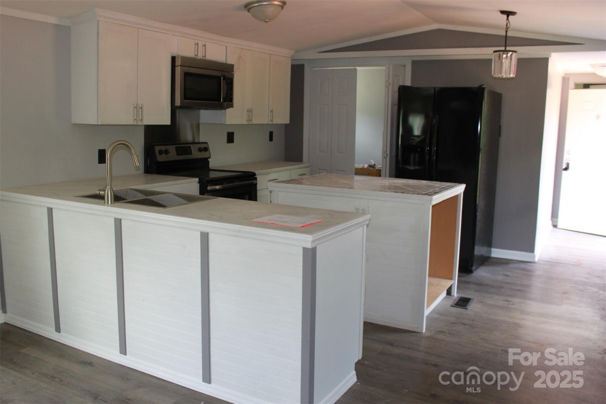 1316 Hopper Road Rutherfordton, NC 28139 - Photo 14 of 42 a kitchen with stainless steel appliances granite countertop a sink and a refrigerator
