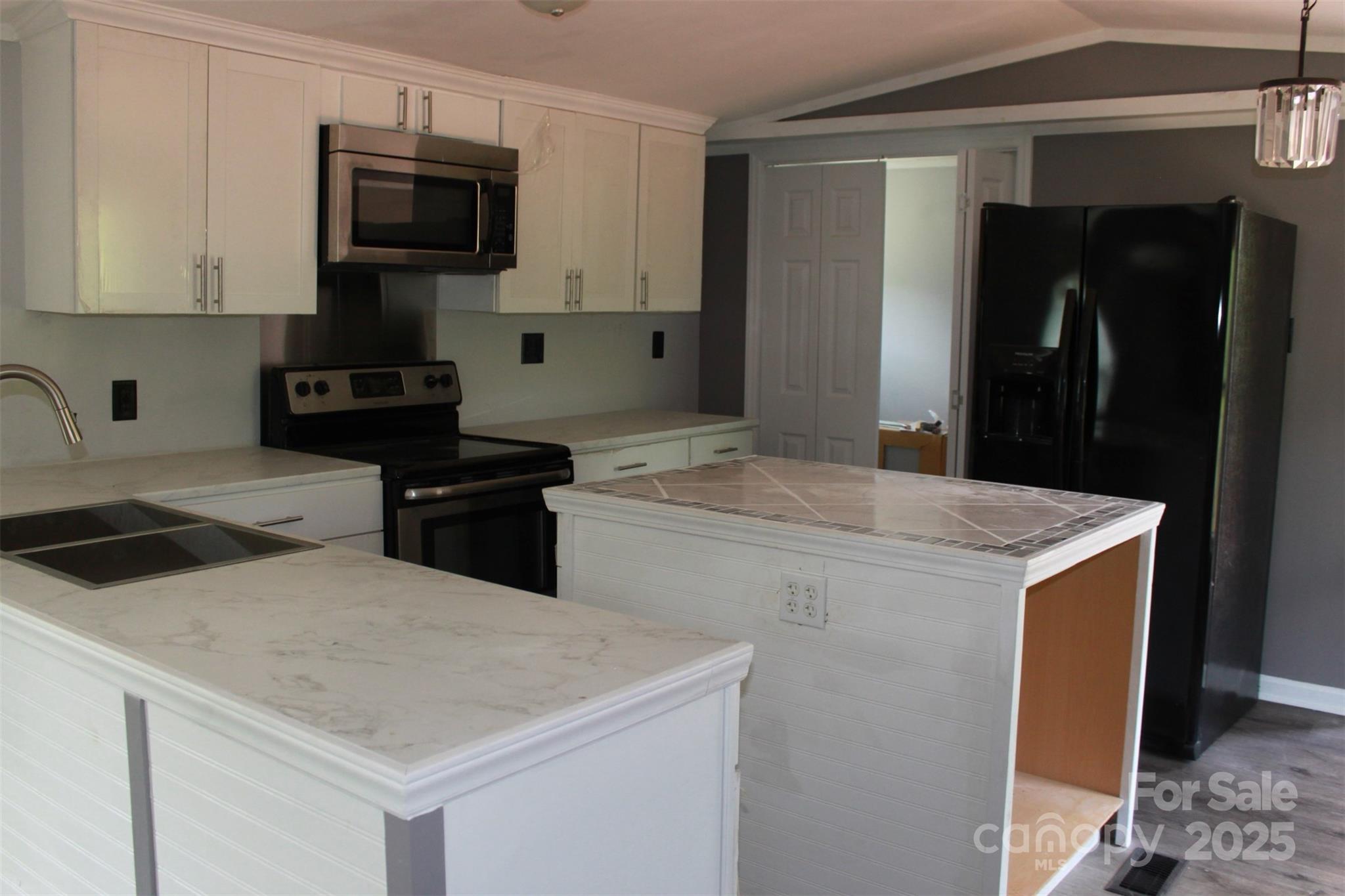 1316 Hopper Road Rutherfordton, NC 28139 - Photo 16 of 42 a kitchen with a stove and a refrigerator