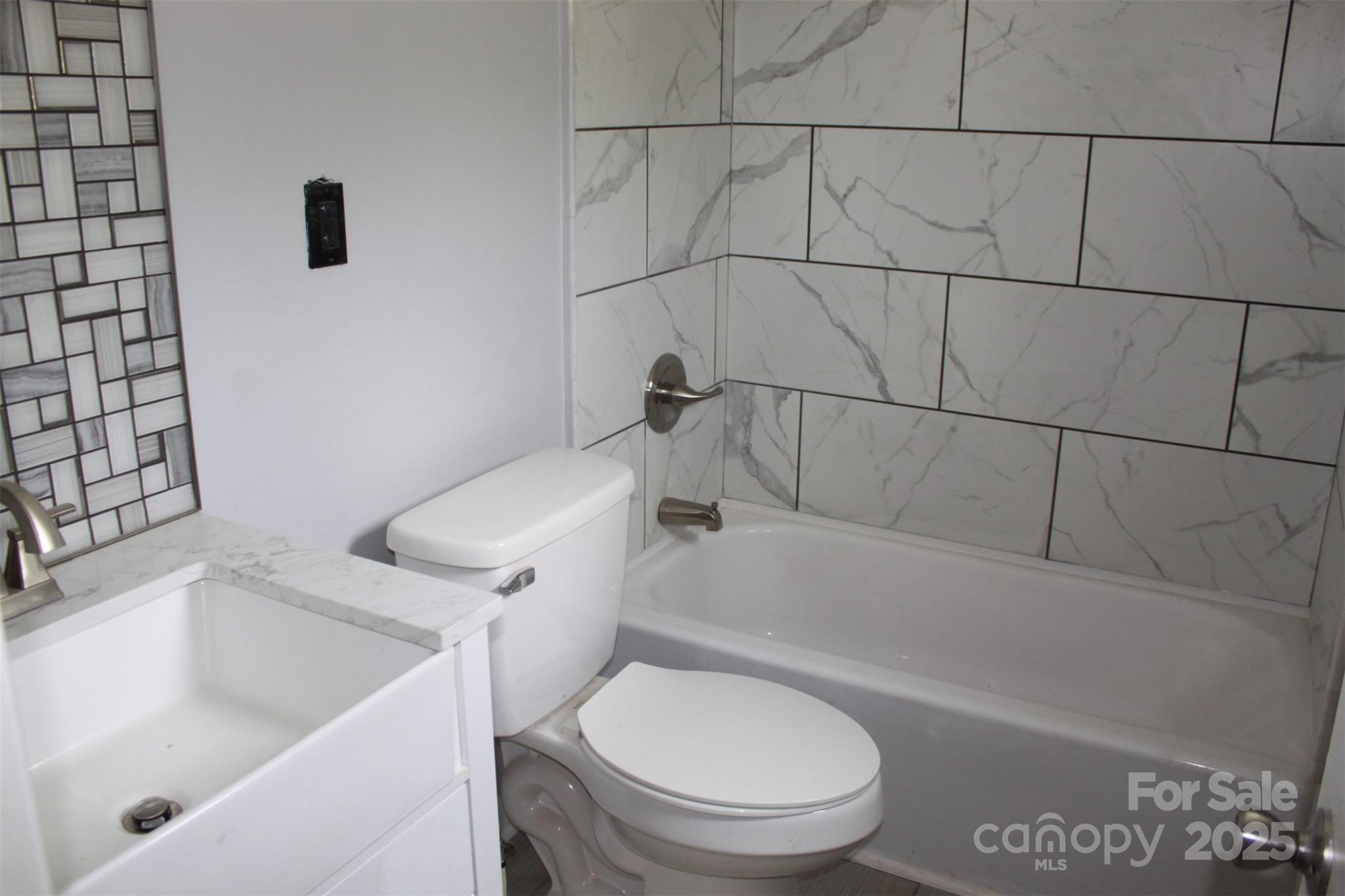 1316 Hopper Road Rutherfordton, NC 28139 - Photo 24 of 42 a white toilet sitting next to a bath tub