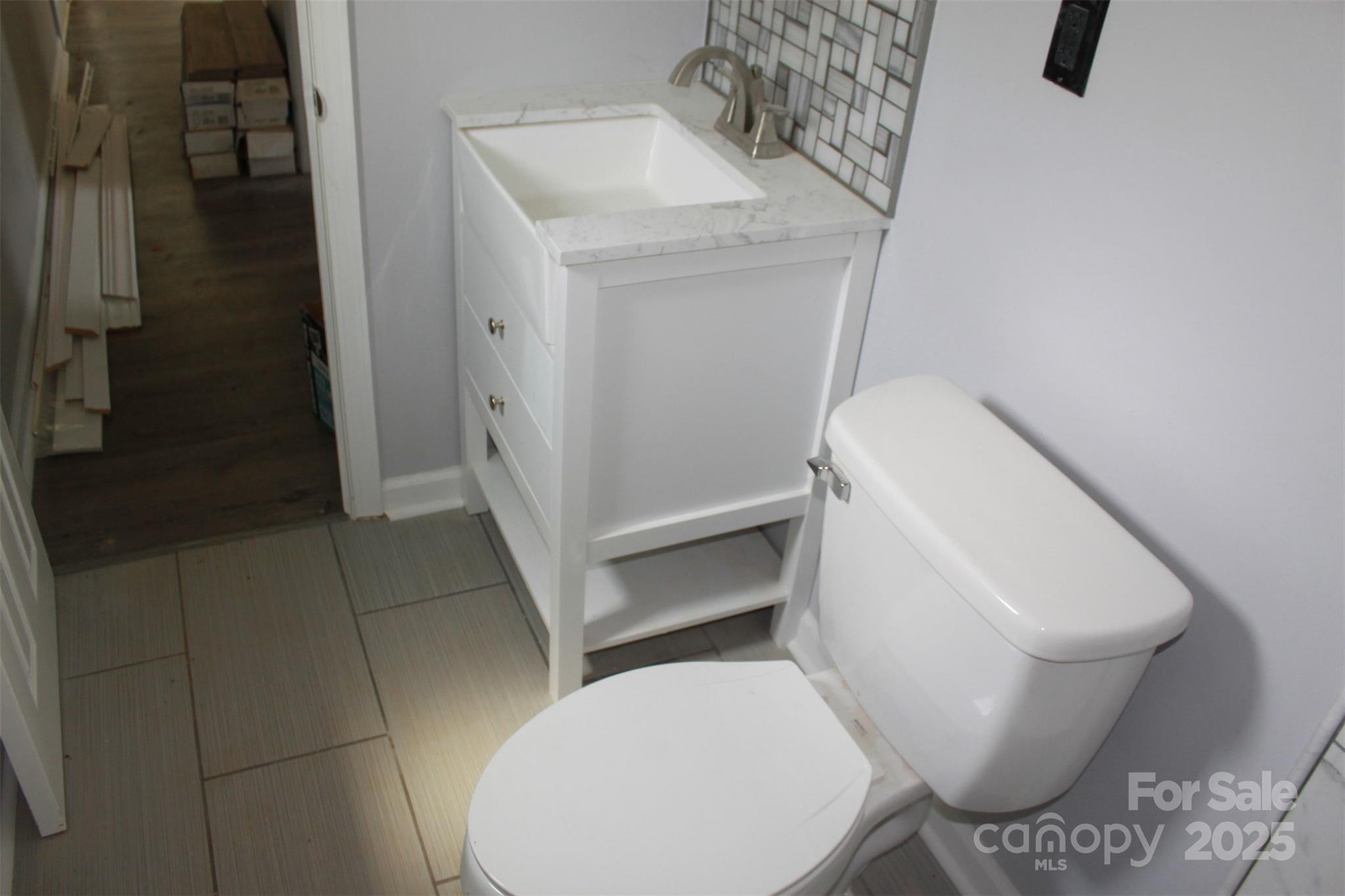 1316 Hopper Road Rutherfordton, NC 28139 - Photo 25 of 42 a white toilet sitting next to a bathroom sink