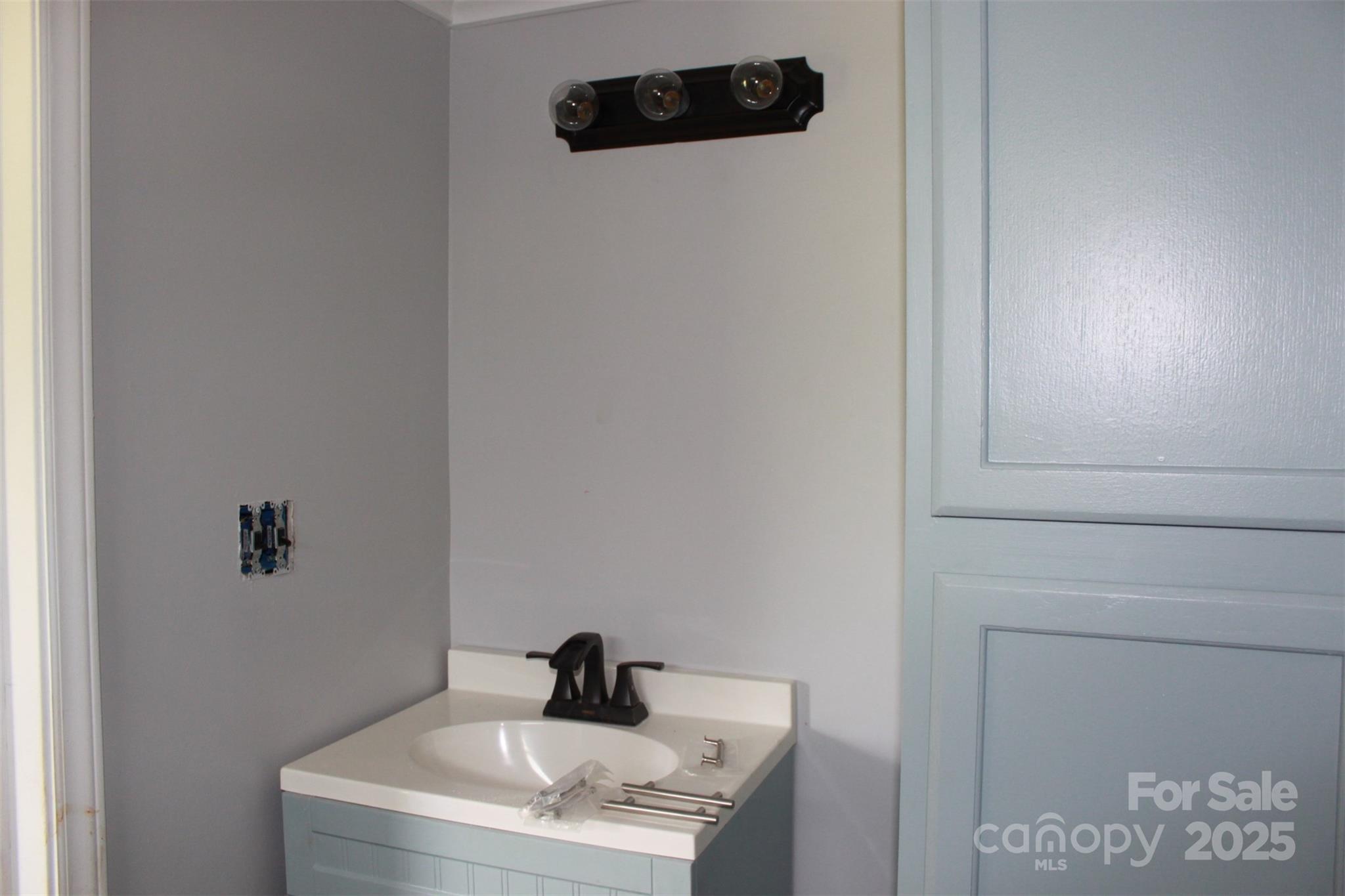1316 Hopper Road Rutherfordton, NC 28139 - Photo 37 of 42 a bathroom with a sink and mirror