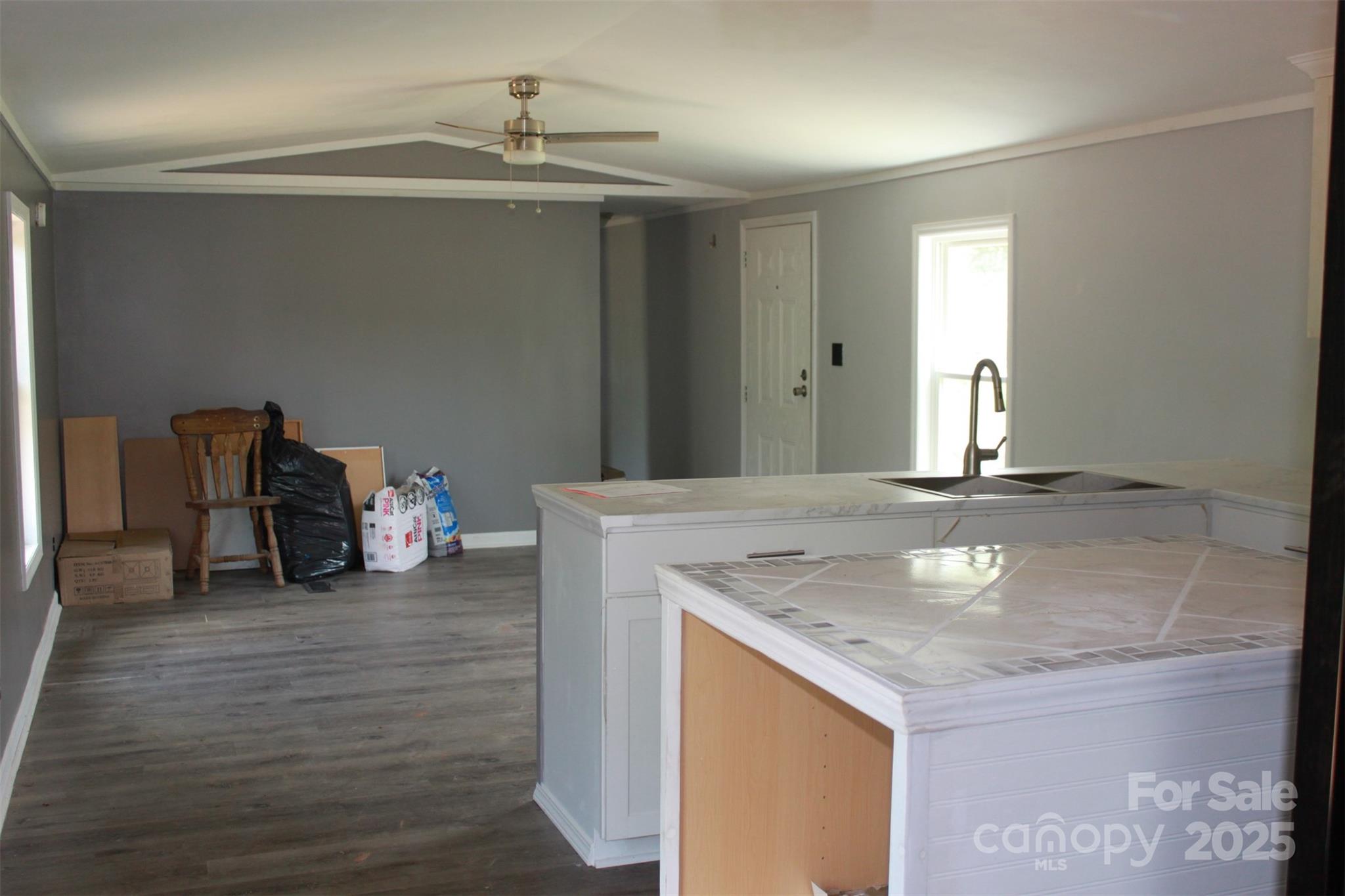 1316 Hopper Road Rutherfordton, NC 28139 - Photo 40 of 42 a view of a livingroom with wooden floor and a ceiling fan
