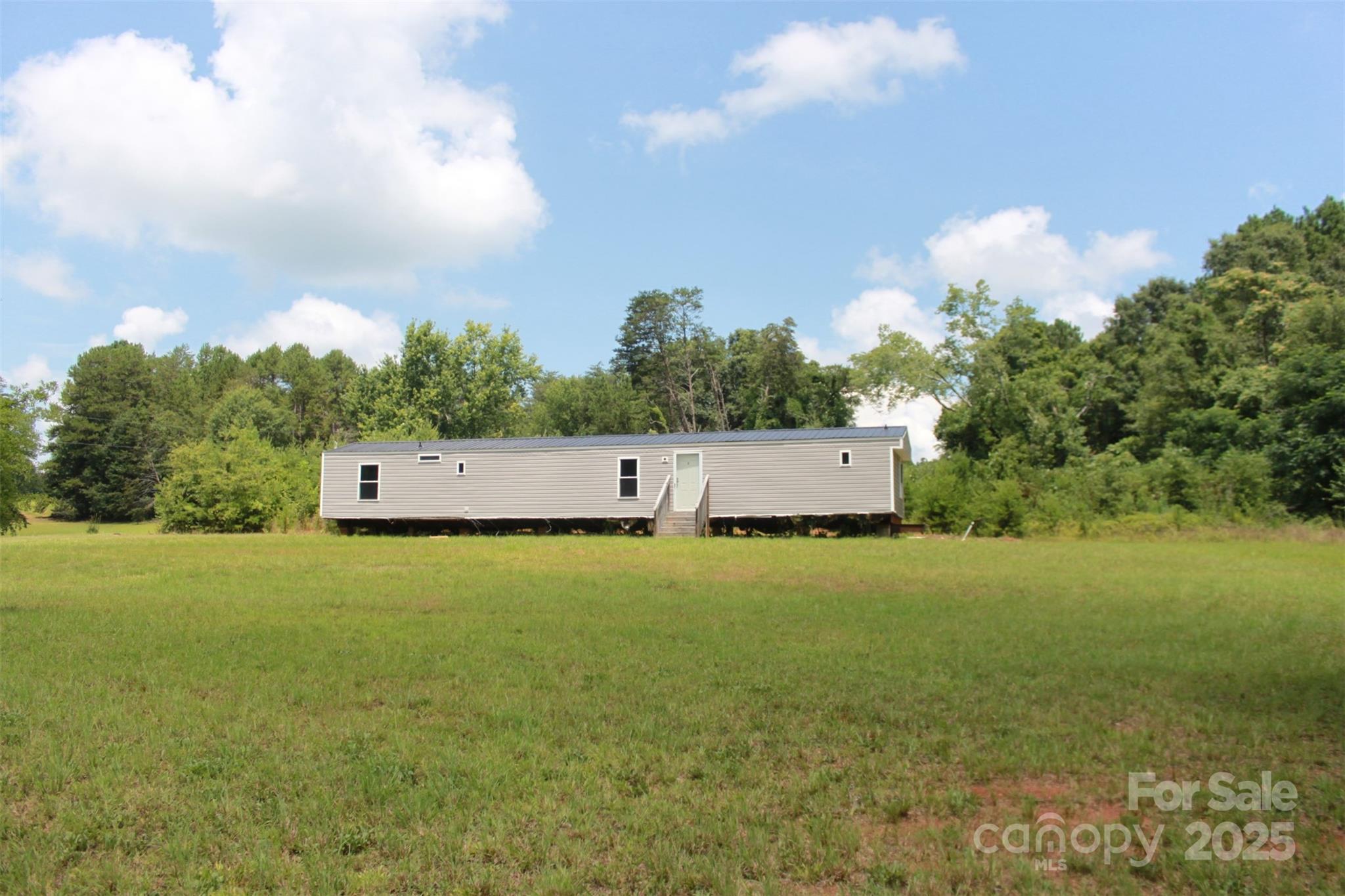 1316 Hopper Road Rutherfordton, NC 28139 - Photo 10 of 42 a house view with swimming pool and trees in the background