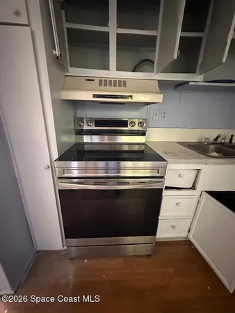 a stove top oven sitting inside of a kitchen