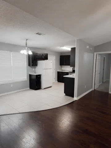 a kitchen with a refrigerator and a sink