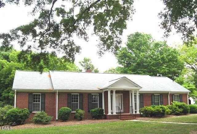 a front view of a house with yard porch and green space