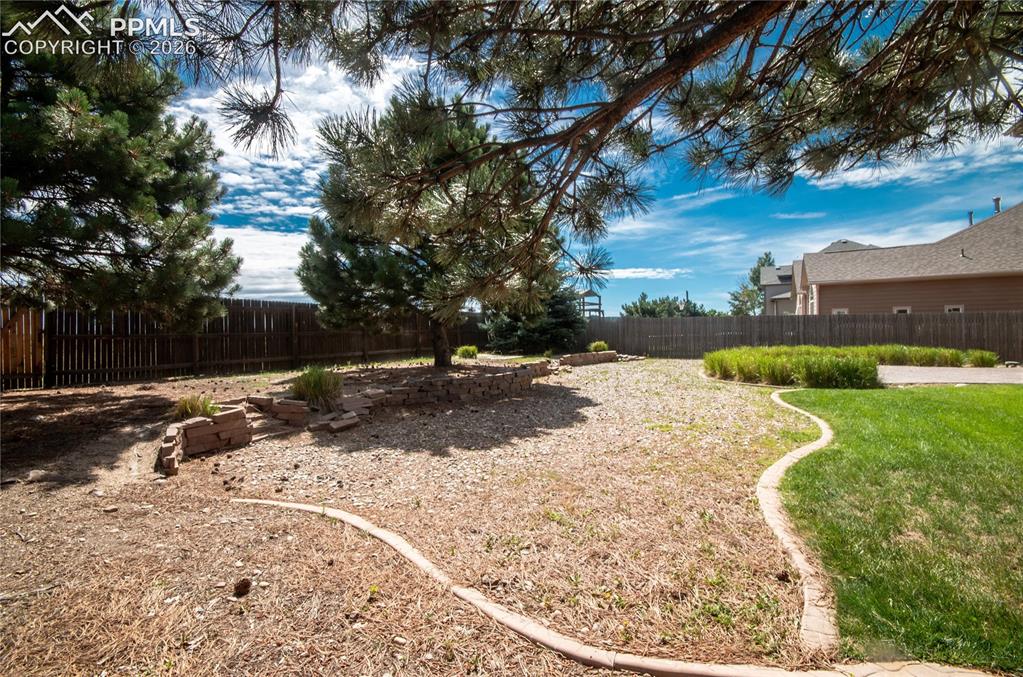 9443 St.George Road Peyton, CO 80831 - Photo 43 of 45 a view of outdoor space with deck and tree