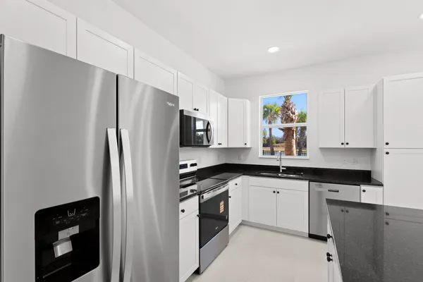 a kitchen with stainless steel appliances a refrigerator and a stove top oven