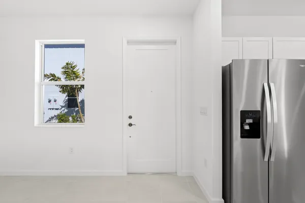 a kitchen with granite countertop white cabinets and stainless steel appliances