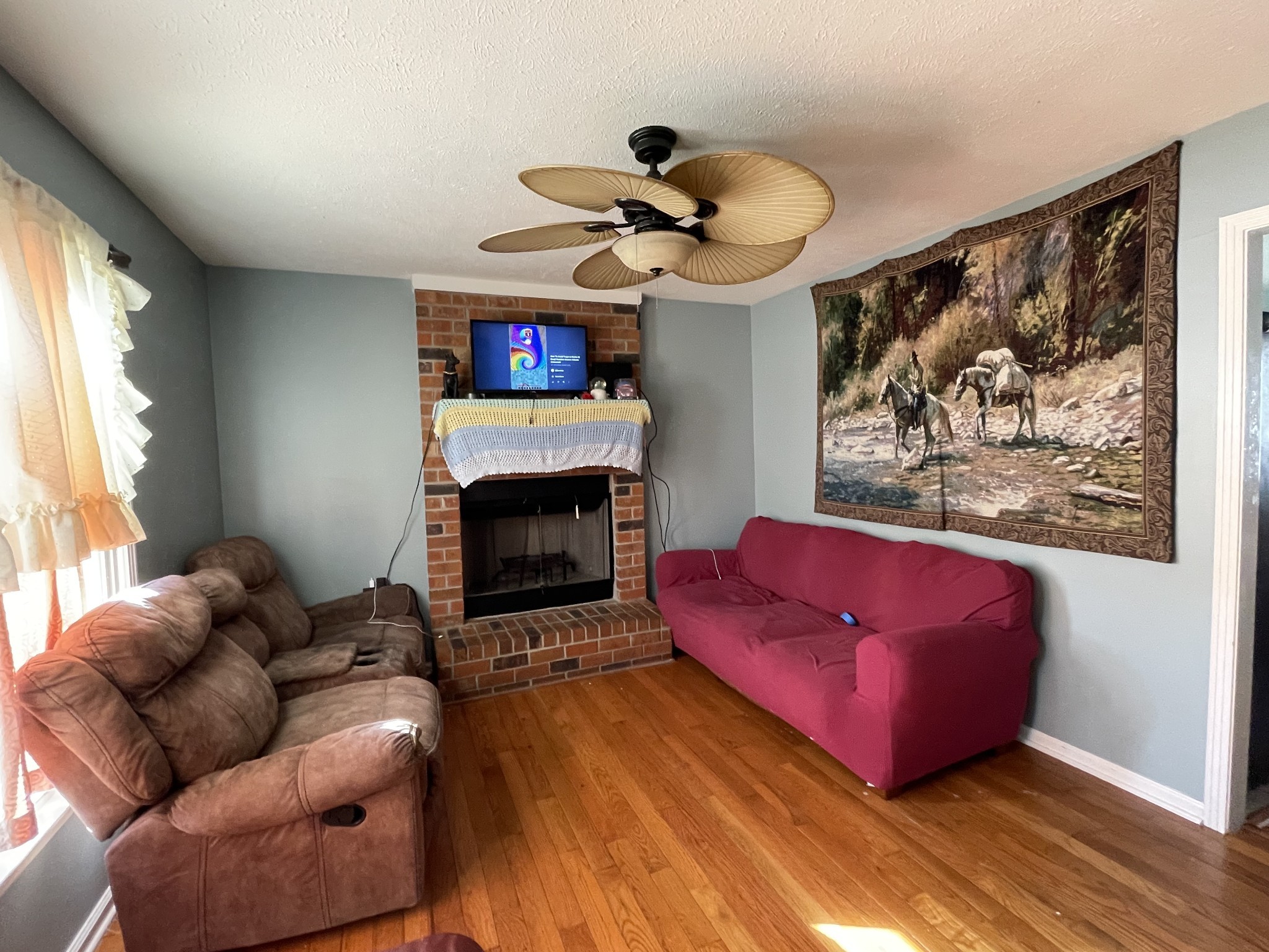552 Piccadilly Row Antioch, TN 37013 - Photo 6 of 36 a living room with furniture a flat screen tv and a fireplace