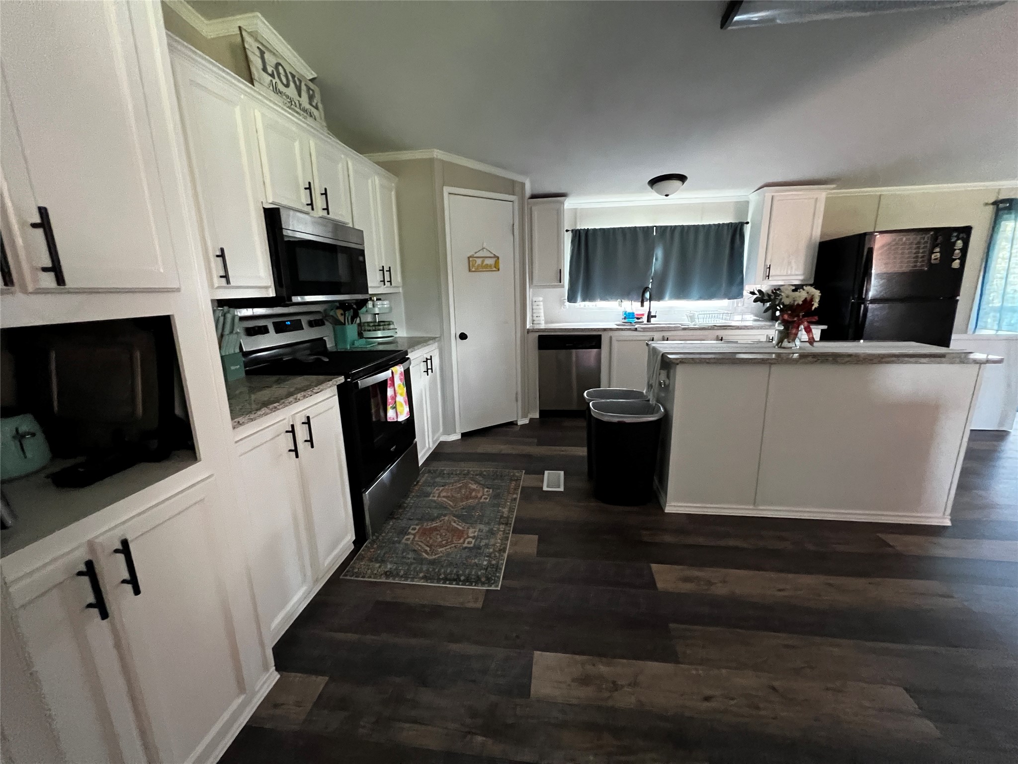 2346 Pr 1105 Midway, TX 75850 - Photo 11 of 25 a kitchen with stainless steel appliances kitchen island granite countertop a sink a stove top oven a chimney and a center island