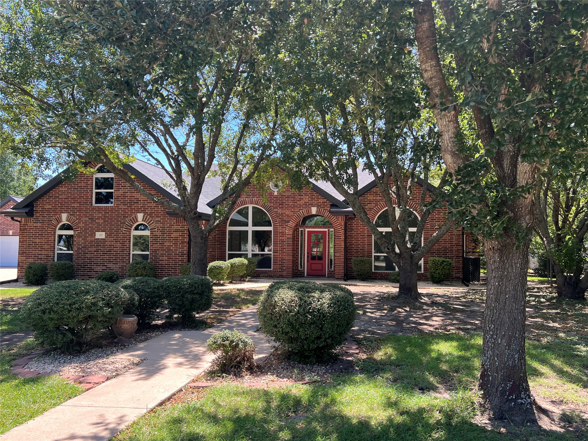 117 Cotton Rows Lane Taylor, TX 76574 - Photo 11 of 35 Tudor home with brick siding, welcoming sidewalks, and gardens.