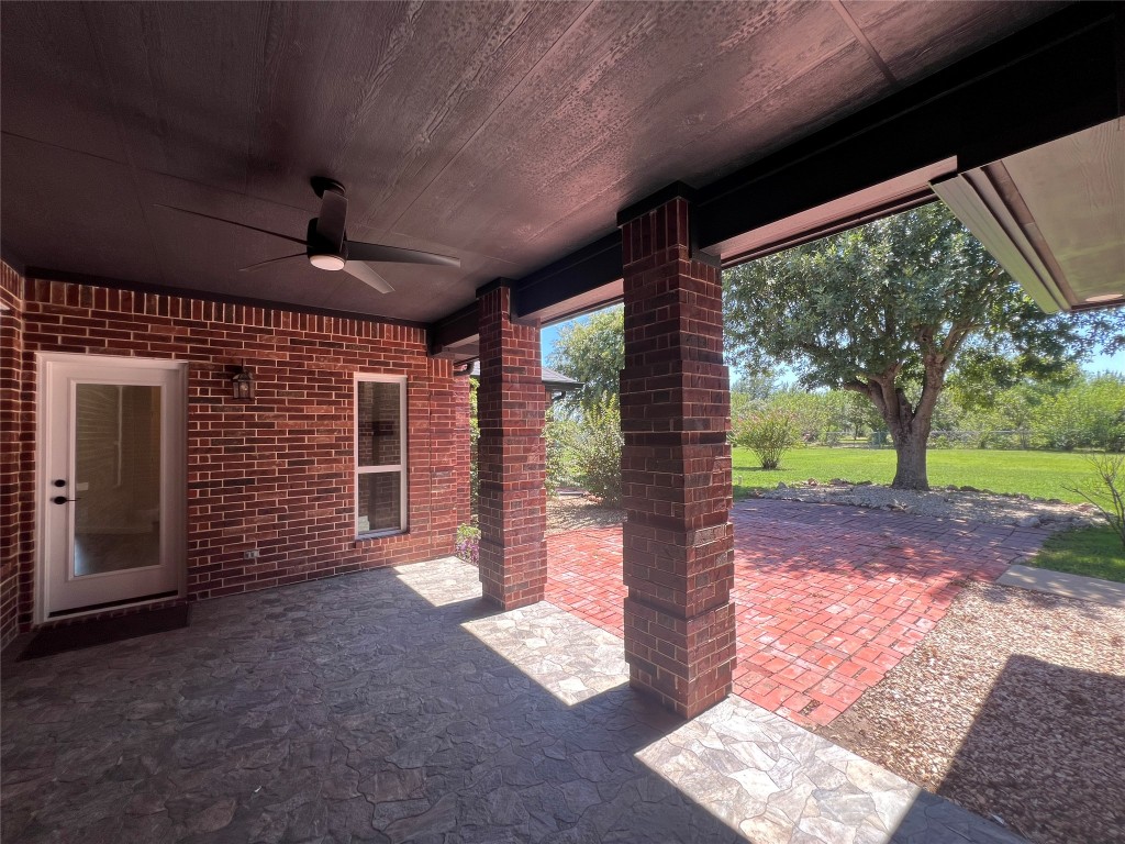 117 Cotton Rows Lane Taylor, TX 76574 - Photo 16 of 35 View of patio with ceiling fan overlooking the expansive yard
