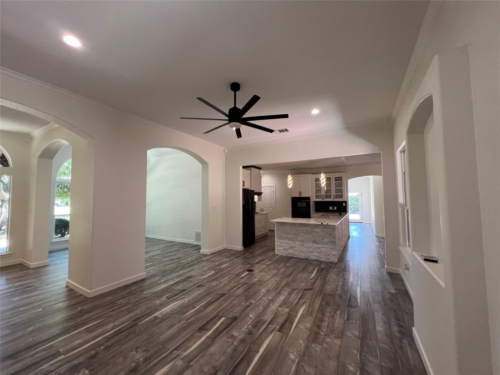 117 Cotton Rows Lane Taylor, TX 76574 - Photo 2 of 35 Gorgeous living room with crown molding, dark wood finished floors, ceiling fan, recessed and lighting.