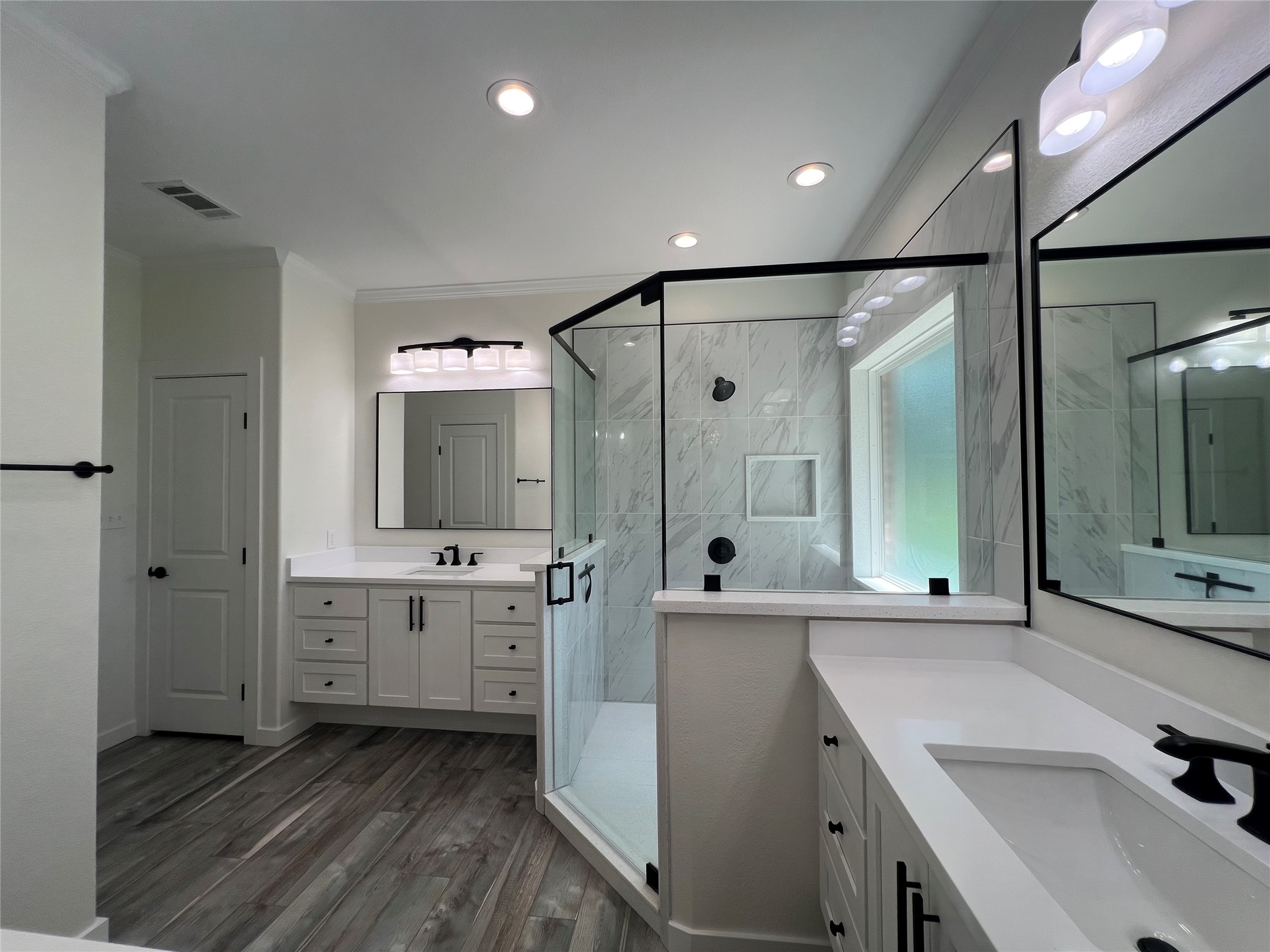 117 Cotton Rows Lane Taylor, TX 76574 - Photo 23 of 35 Owner's suite bathroom with standing shower, double vanities, and a dressing mirror and vanity.