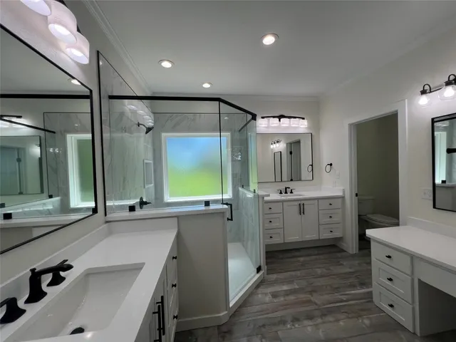 a large bathroom with a double vanity sink mirror and shower