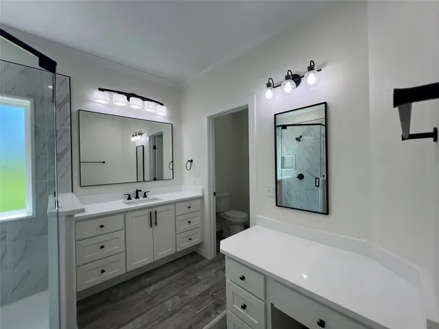 a spacious bathroom with a double vanity sink and mirror