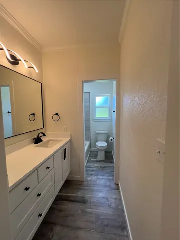 a spacious bathroom with a double vanity sink and a mirror