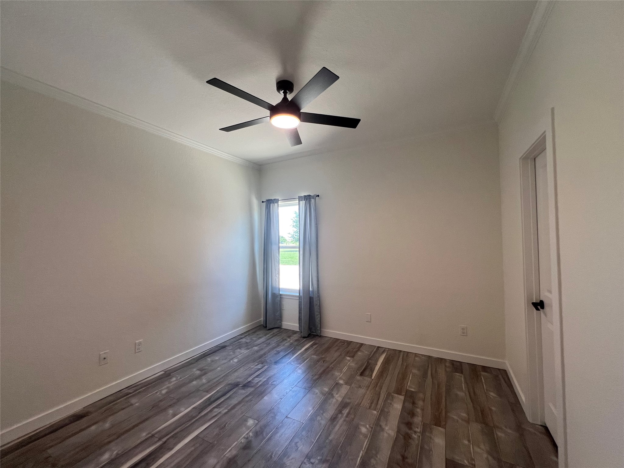 117 Cotton Rows Lane Taylor, TX 76574 - Photo 31 of 35 Spare room with dark wood-style flooring, ornamental molding, and a ceiling fan