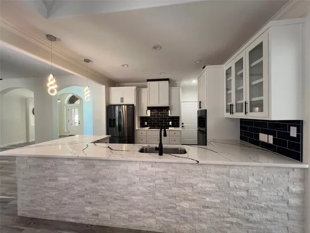 a view of kitchen with refrigerator and window