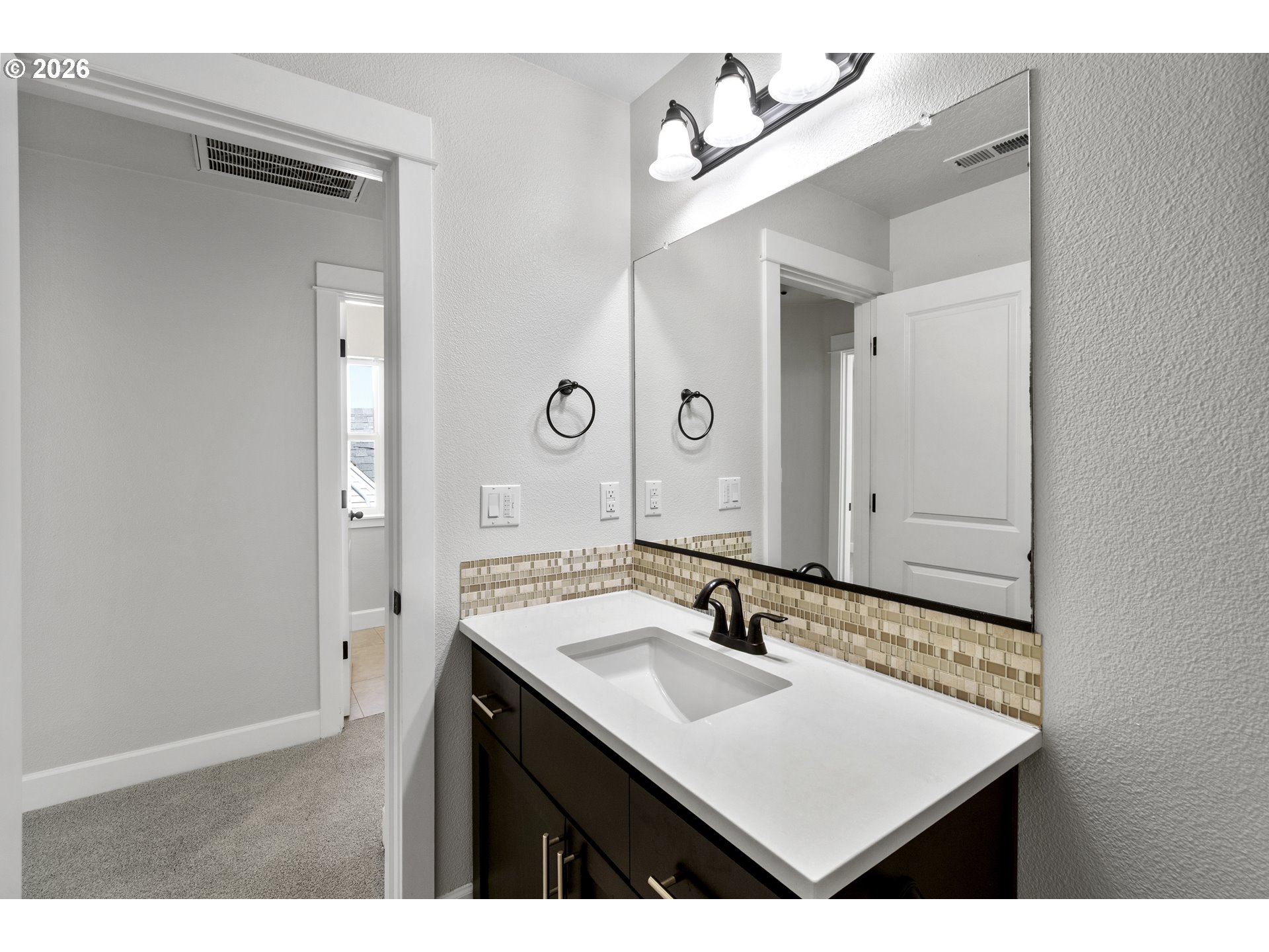 7473 Northeast Fremont Street Portland, OR 97213 - Photo 32 of 41 a bathroom with a sink vanity and a mirror