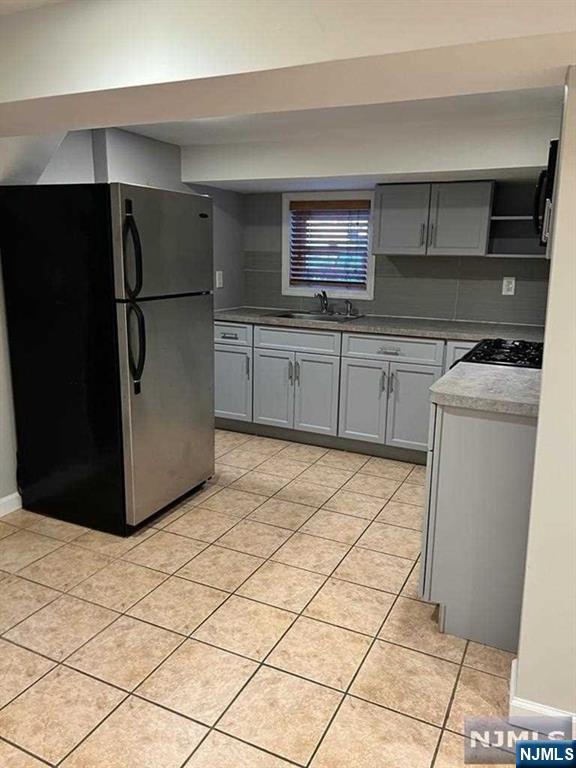 493 Morningside Avenue, Unit 1 Fairview, NJ 07022 - Photo 4 of 7 a kitchen with stainless steel appliances a refrigerator sink and microwave