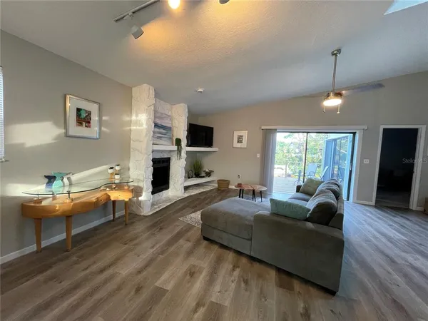 a living room with fireplace furniture and a wooden floor