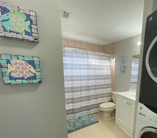 a bathroom with a toilet and a shower curtain
