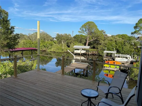 a roof deck with table and chairs a barbeque