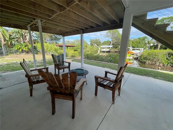 a view of a porch with furniture and a yard