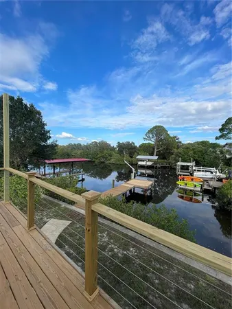 a view of a terrace with lawn chairs and iron fence