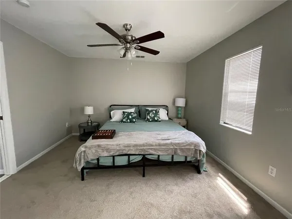 a bedroom with a bed and window
