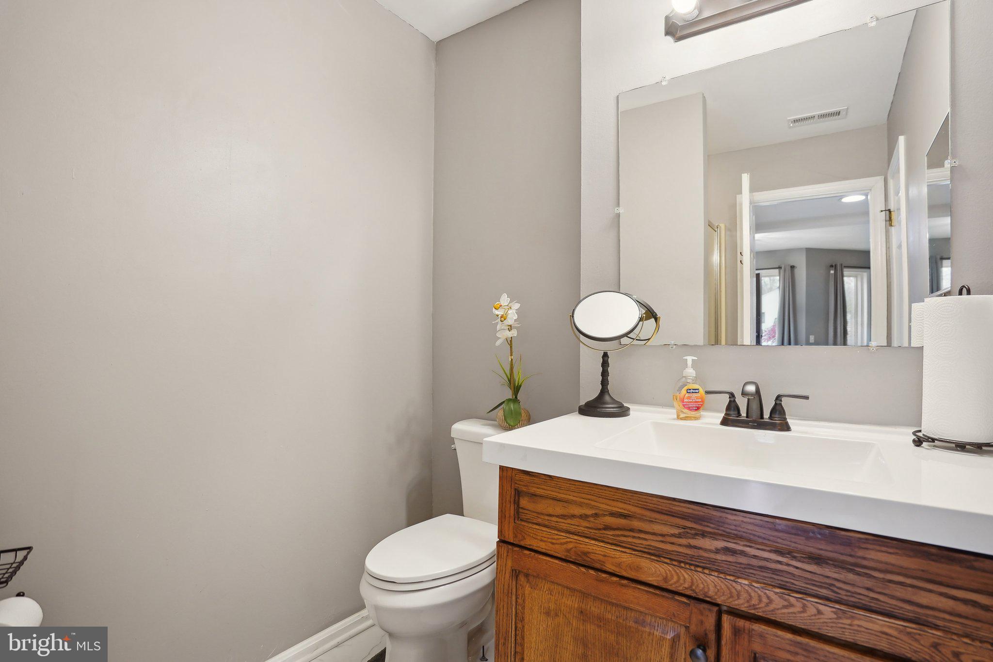 3111 Courtside Road Bowie, MD 20721 - Photo 37 of 41 a bathroom with a sink toilet and mirror