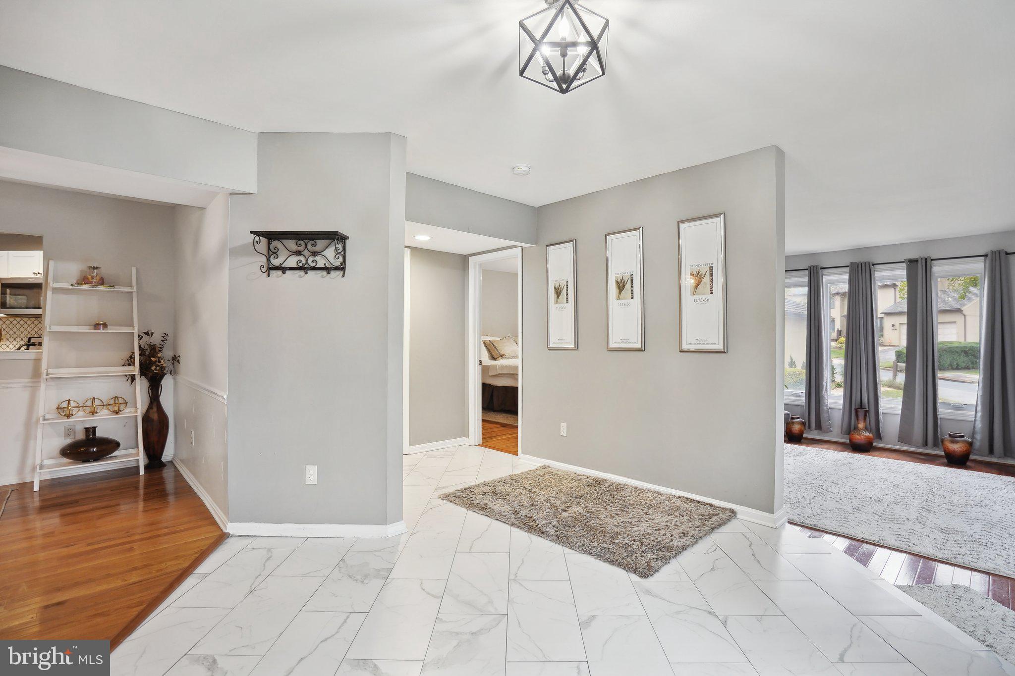 3111 Courtside Road Bowie, MD 20721 - Photo 7 of 41 a view of a livingroom with wooden floor and a chandelier