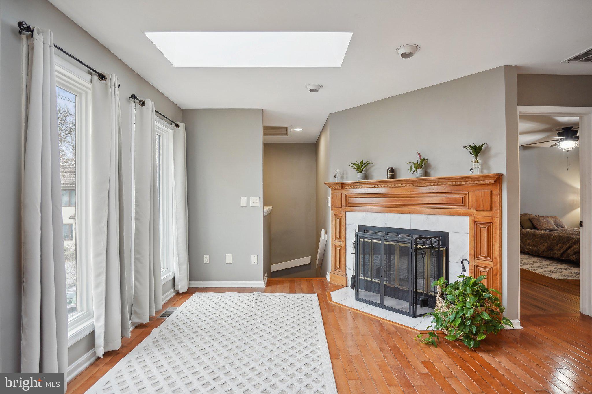 3111 Courtside Road Bowie, MD 20721 - Photo 9 of 41 a view of an empty room with a fireplace and a window