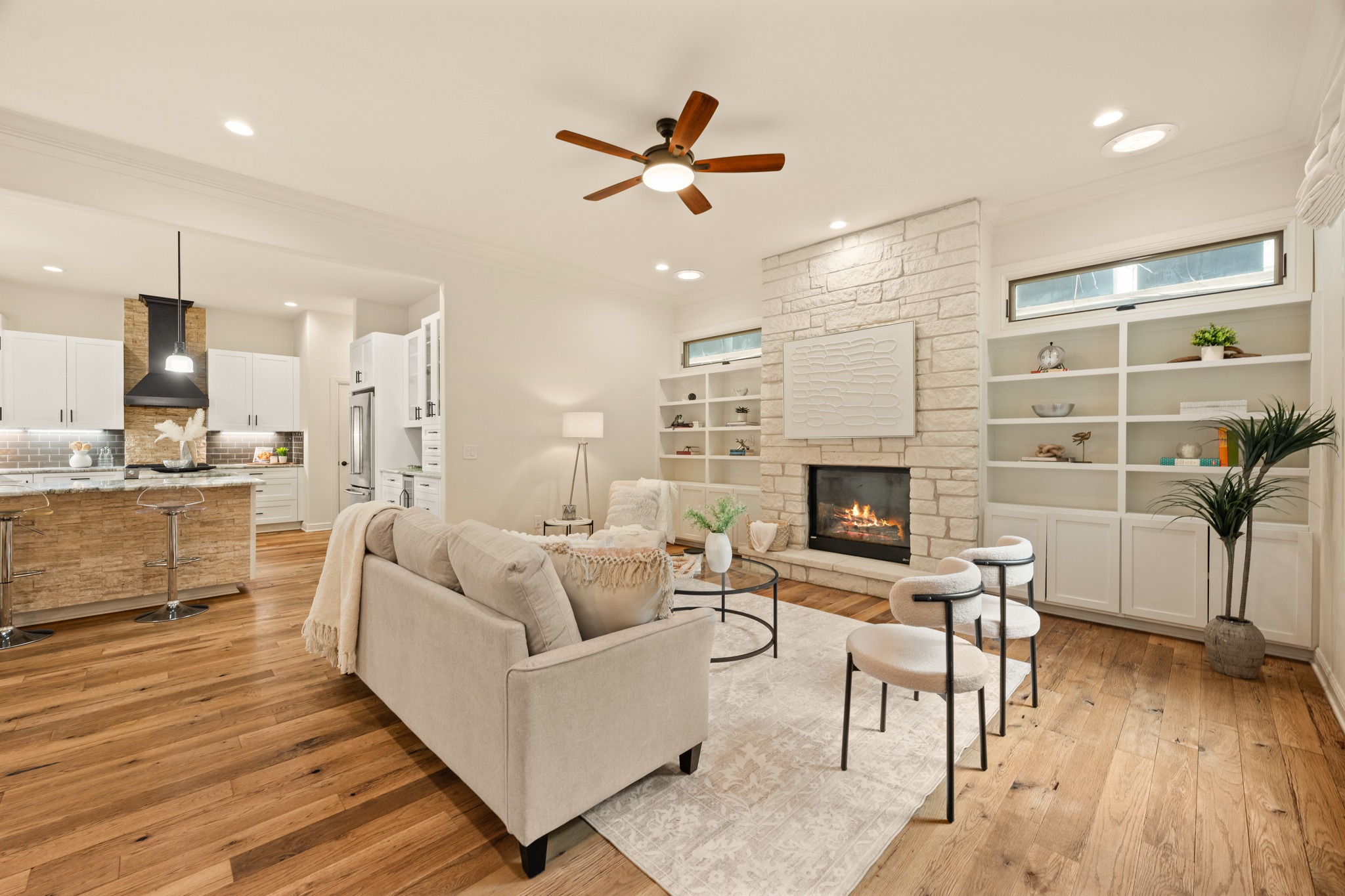 3907 Bailey Lane Austin, TX 78756 - Photo 6 of 40 A floor to ceiling stone fireplace dominates the living room and is flanked by custom bookshelves that give this room a contemporary, coastal feel