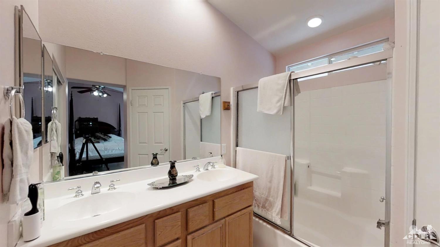 80609 Declaration Avenue Indio, CA 92201 - Photo 22 of 30 a bathroom with a sink vanity granite shower and a mirror
