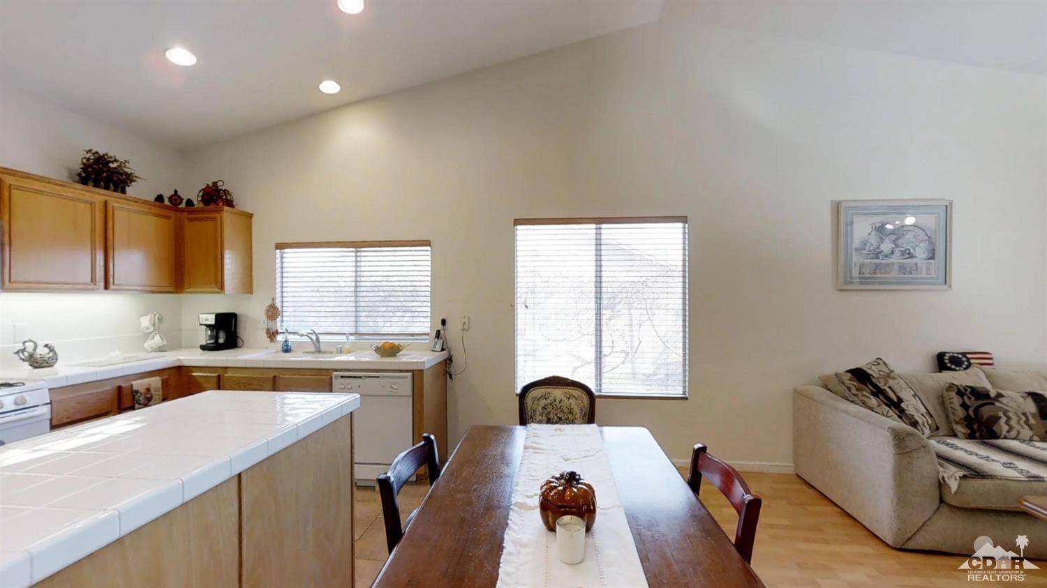 80609 Declaration Avenue Indio, CA 92201 - Photo 4 of 30 a view of a kitchen with a sink a microwave and cabinets